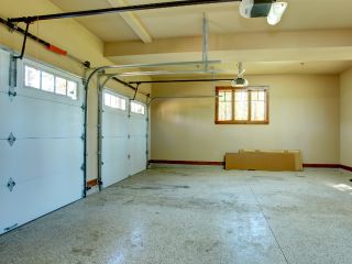 Electric Garage Door Installation – Garage Door Repair Treasure Island Spacious two-car garage with modern electric garage doors, ceiling-mounted openers, and natural light, illustrating electric garage door services in Treasure Island.